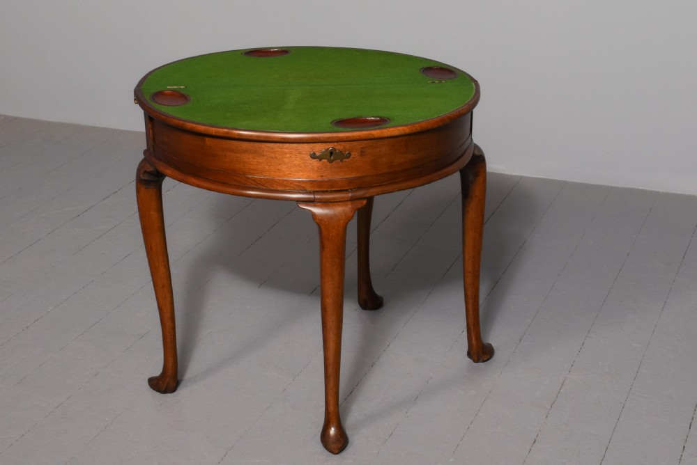 A George III demilune mahogany triple-top games table with cabriole legs, pad feet, and a central brass escutcheon on the apron. View III