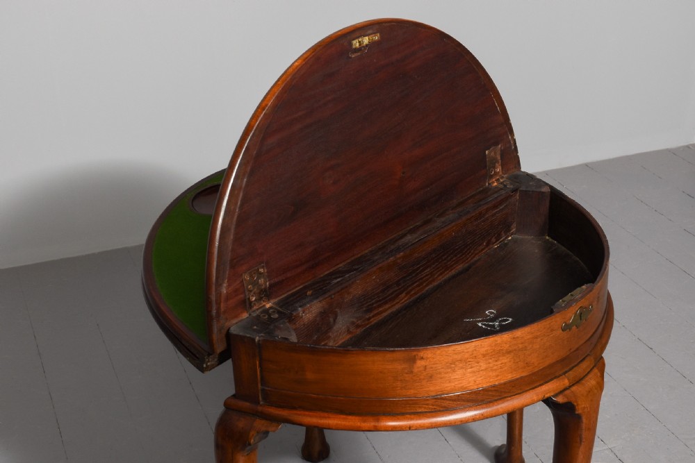 A George III demilune mahogany triple-top games table with cabriole legs, pad feet, and a central brass escutcheon on the apron. View IV