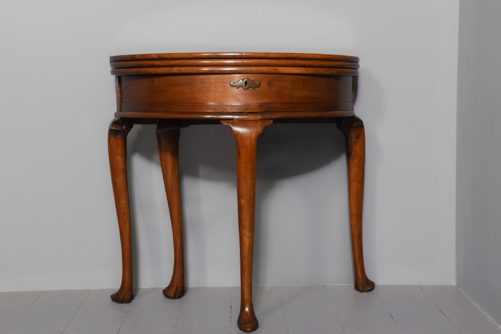 A George III demilune mahogany triple-top games table with cabriole legs, pad feet, and a central brass escutcheon on the apron. View VIII