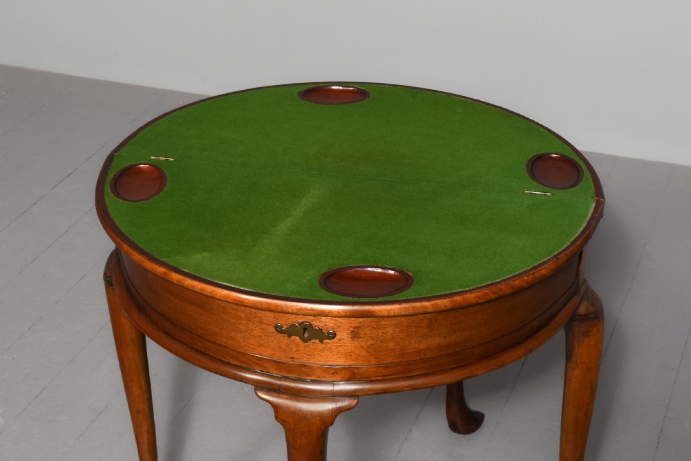 A George III demilune mahogany triple-top games table with cabriole legs, pad feet, and a central brass escutcheon on the apron. View IX