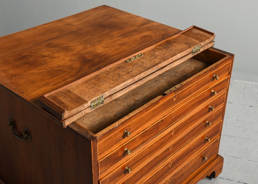 An 18th-century George III mahogany floor-standing folio cabinet featuring shallow drawers with brass knobs, boxwood inlay, brass side carrying handles, and shaped bracket feet. View IV