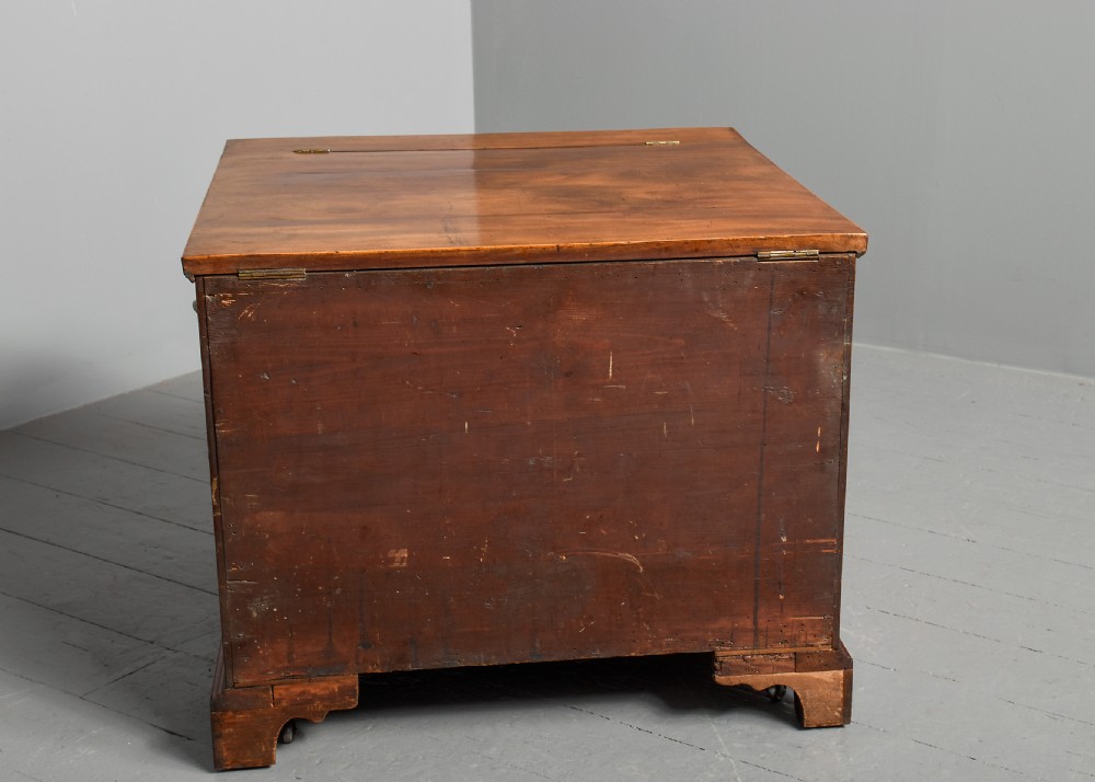 An 18th-century George III mahogany floor-standing folio cabinet featuring shallow drawers with brass knobs, boxwood inlay, brass side carrying handles, and shaped bracket feet. View VII