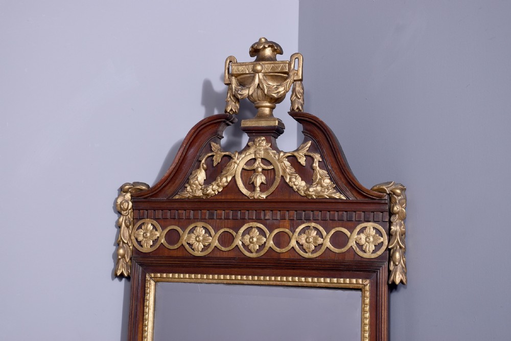 A tall Swedish Gustavian mahogany pier mirror featuring an urn finial cresting and gold gilt decorative swags. View II
