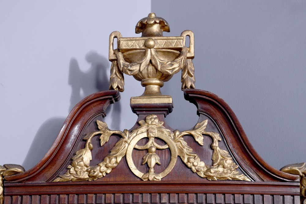 A tall Swedish Gustavian mahogany pier mirror featuring an urn finial cresting and gold gilt decorative swags. View IV