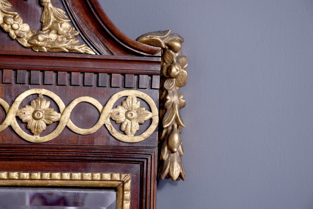 A tall Swedish Gustavian mahogany pier mirror featuring an urn finial cresting and gold gilt decorative swags. View V