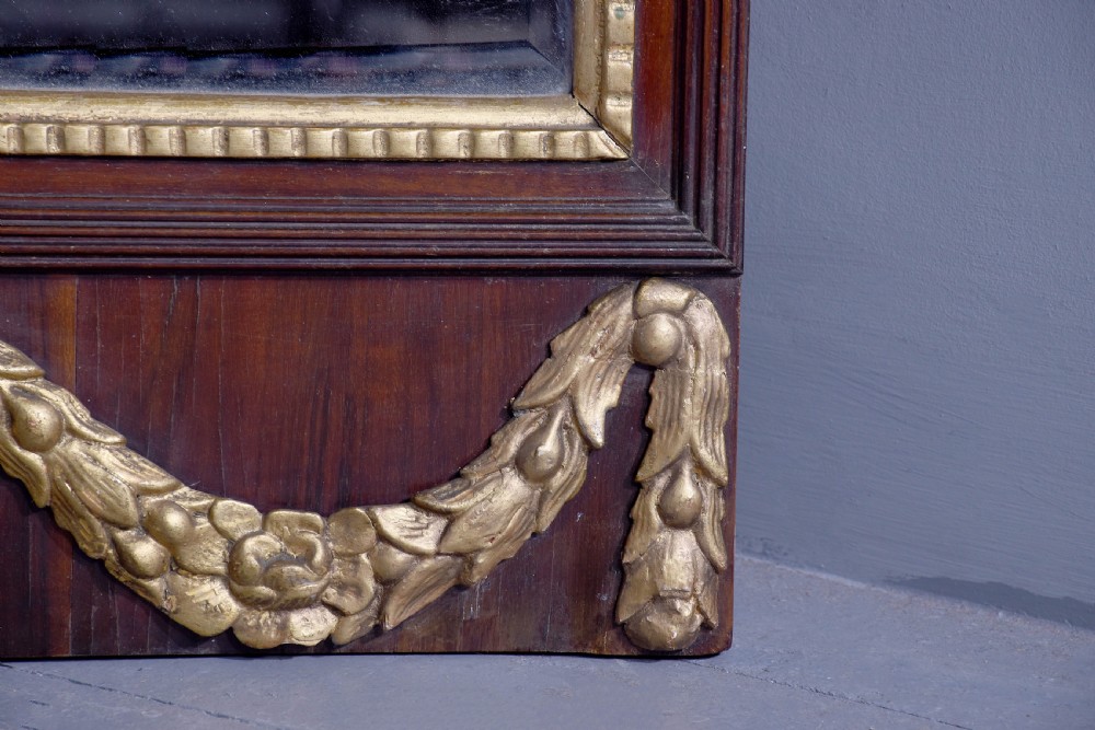 A tall Swedish Gustavian mahogany pier mirror featuring an urn finial cresting and gold gilt decorative swags. View VII