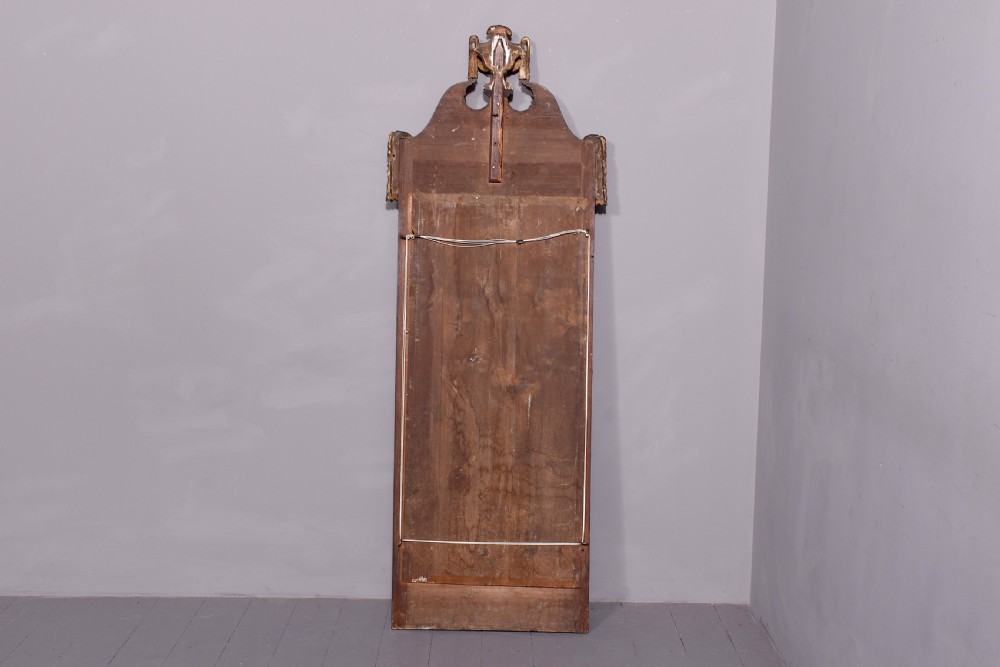 A tall Swedish Gustavian mahogany pier mirror featuring an urn finial cresting and gold gilt decorative swags. View IX