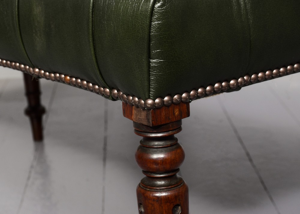 A pair of Regency mahogany benches featuring dark green buttoned leather upholstery trimmed with brass studs, supported by fluted turned legs. View III