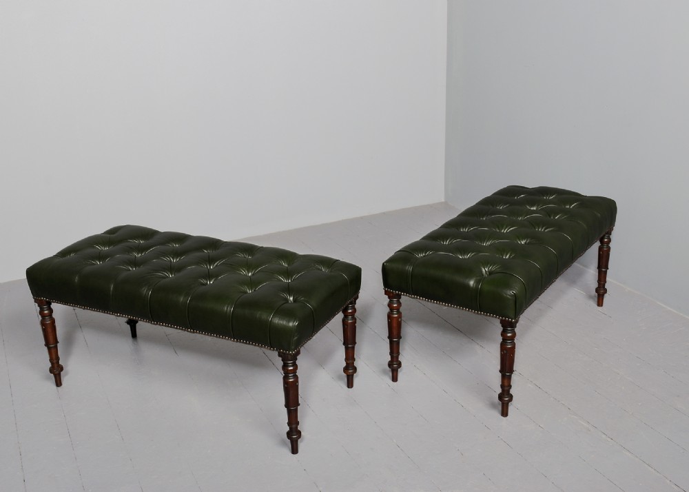 A pair of Regency mahogany benches featuring dark green buttoned leather upholstery trimmed with brass studs, supported by fluted turned legs. View IX