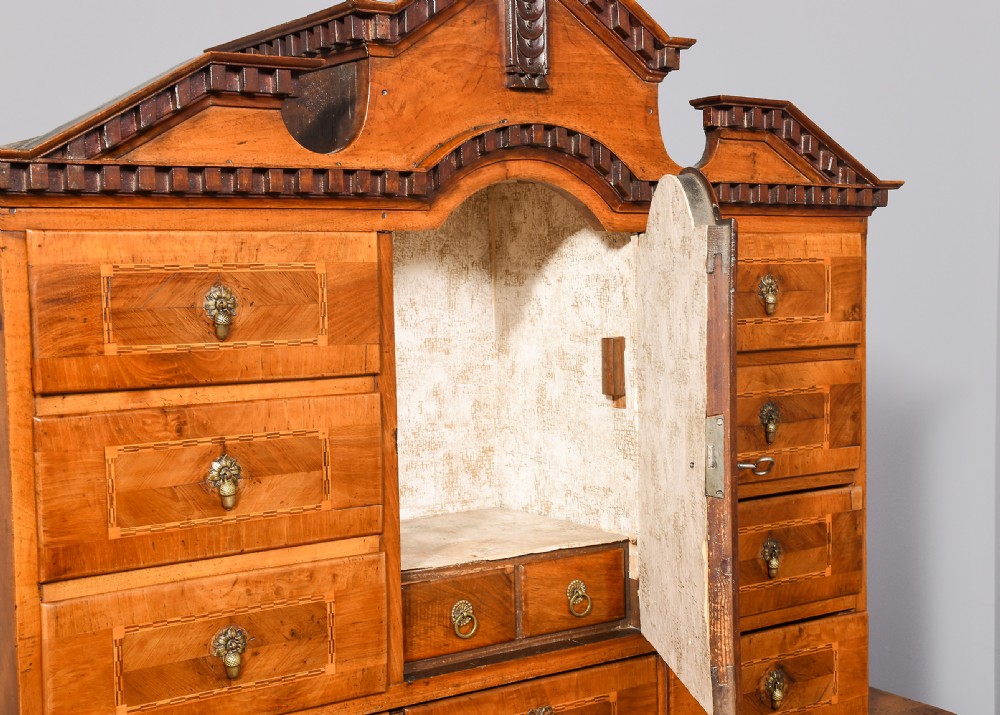 An 18th-century walnut bureau bookcase featuring geometric marquetry, a slant-front writing surface, multiple drawers, and an architectural top pediment. View VII