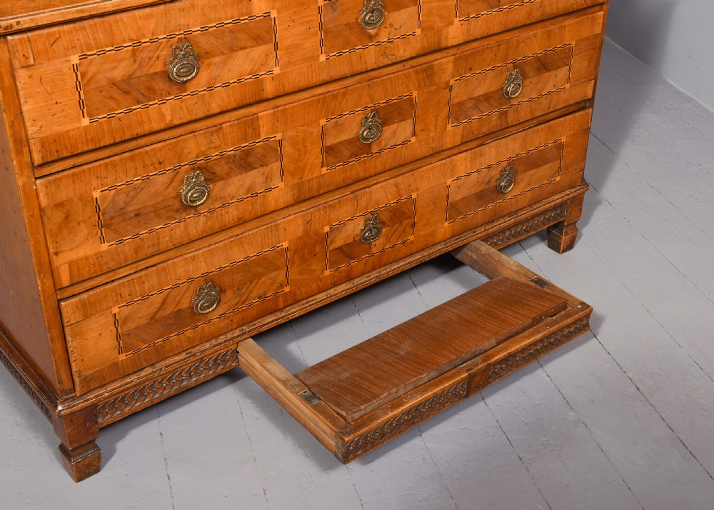 An 18th-century walnut bureau bookcase featuring geometric marquetry, a slant-front writing surface, multiple drawers, and an architectural top pediment. View IX