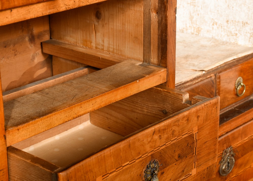 An 18th-century walnut bureau bookcase featuring geometric marquetry, a slant-front writing surface, multiple drawers, and an architectural top pediment. View XV