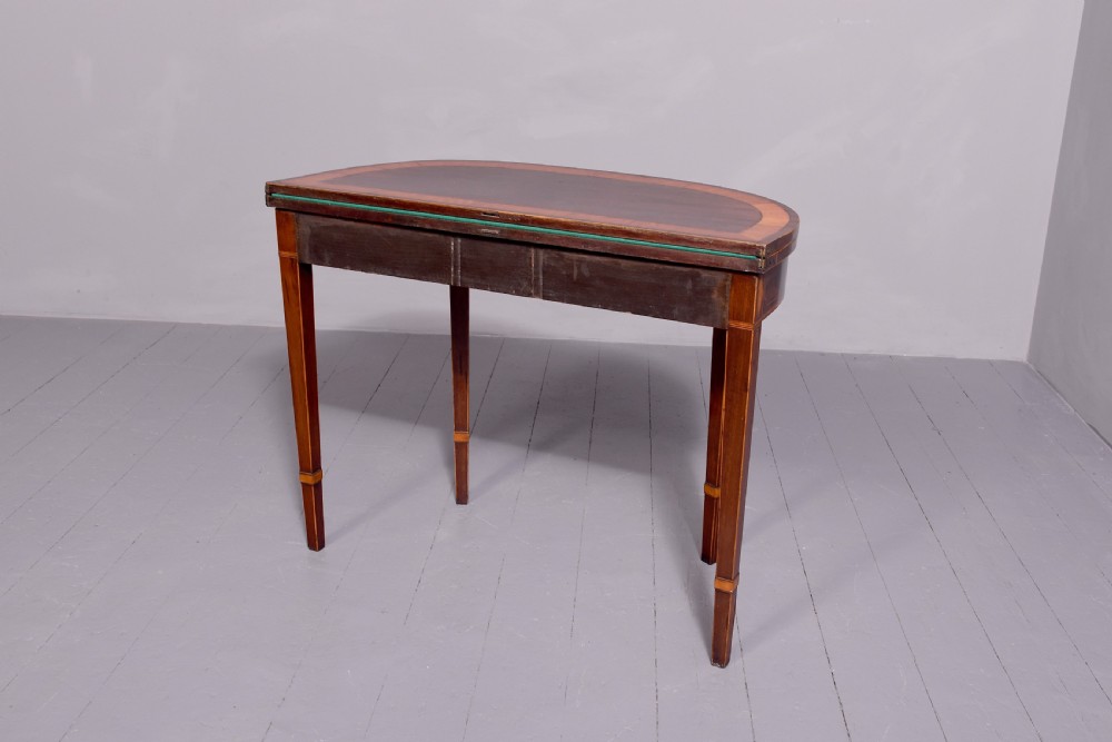A George III rosewood fold-over card table displaying a green baize interior, satinwood stringing, and square tapered legs. View VII
