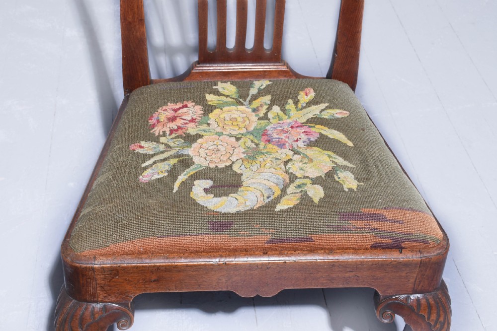 A George II walnut side chair featuring a pierced back splat, floral needlepoint seat, and carved cabriole legs. View II