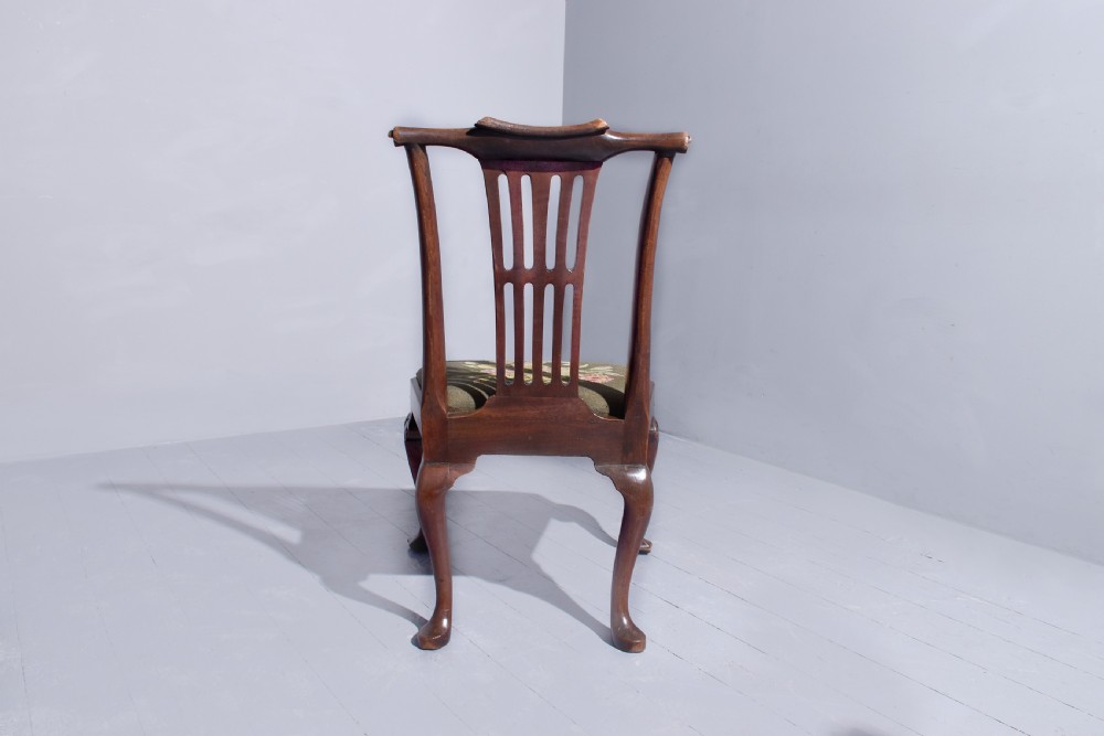 A George II walnut side chair featuring a pierced back splat, floral needlepoint seat, and carved cabriole legs. View IV