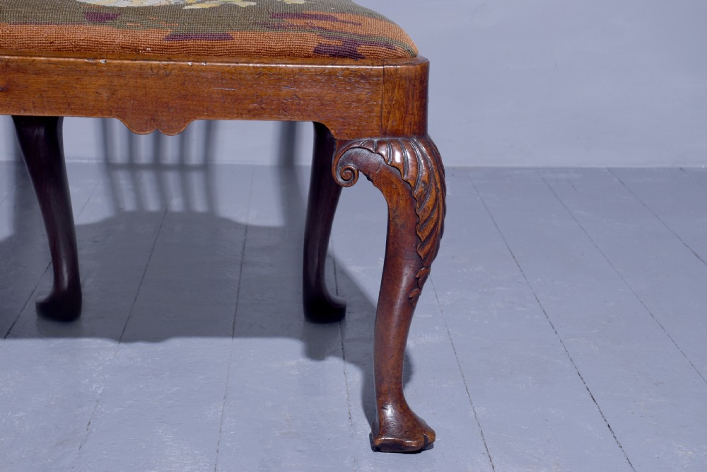 A George II walnut side chair featuring a pierced back splat, floral needlepoint seat, and carved cabriole legs. View V