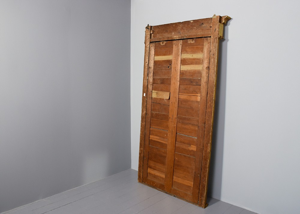 A tall Regency gilded pier mirror featuring a carved architectural cornice, side columns with leaf motifs, and a central classical frieze. View VIII