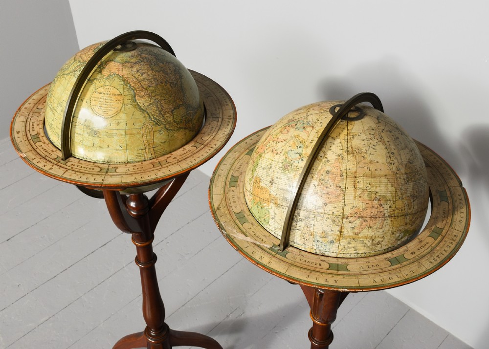 A pair of antique floor-standing globes with brass meridian rings set on turned mahogany tripod stands. View VII