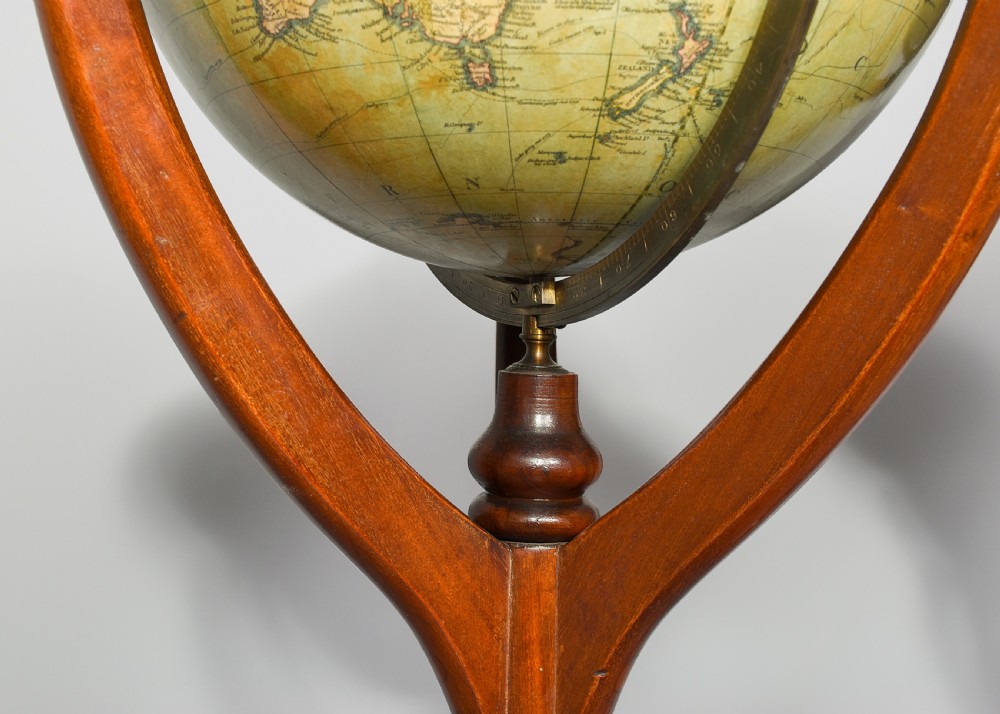 A pair of antique floor-standing globes with brass meridian rings set on turned mahogany tripod stands. View X