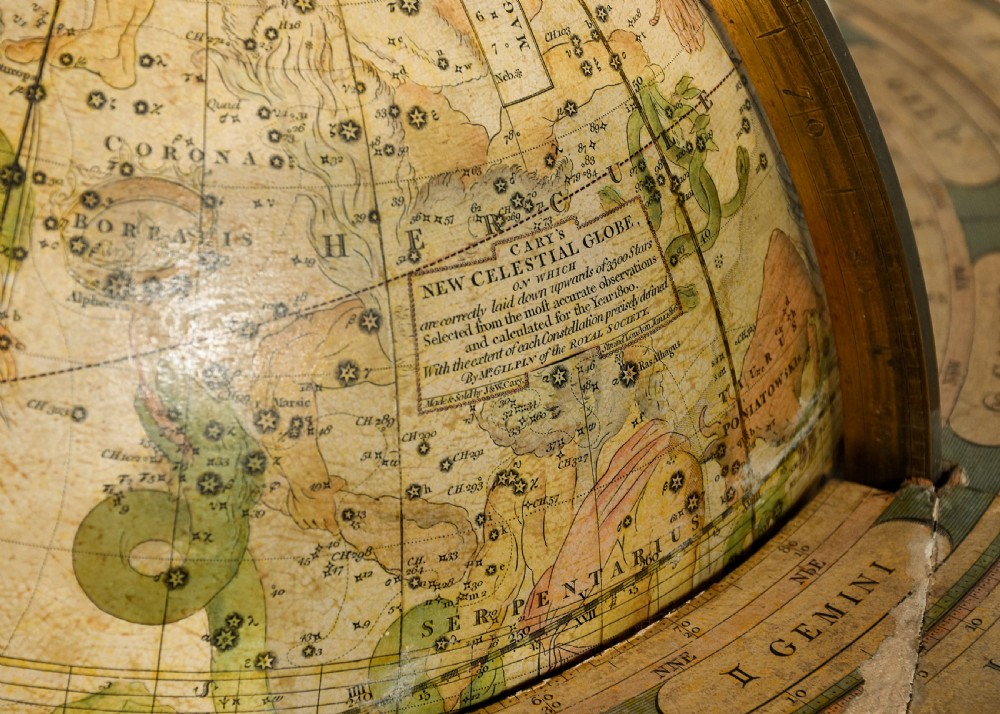 A pair of antique floor-standing globes with brass meridian rings set on turned mahogany tripod stands. View XII