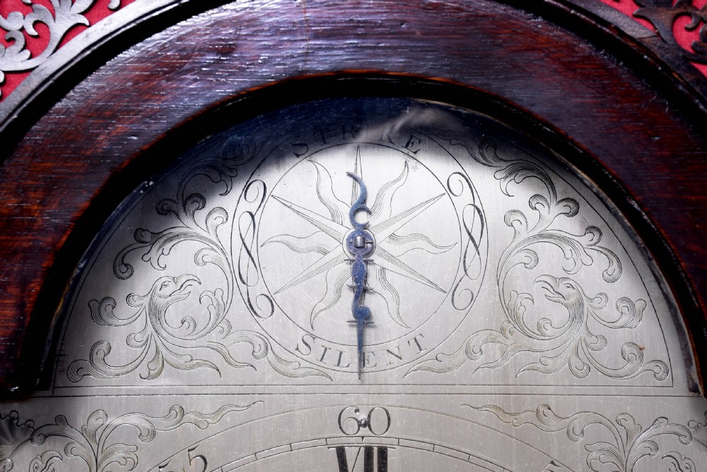 A George III dark mahogany longcase grandfather clock featuring a swan-neck pediment, brass finial, and an engraved brass arch dial. View VII