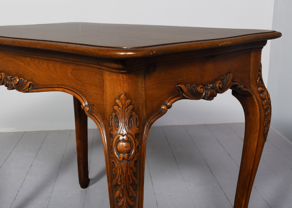A Georgian style mahogany centre table featuring carved cabriole legs, scroll feet, and a serpentine shaped apron. View II