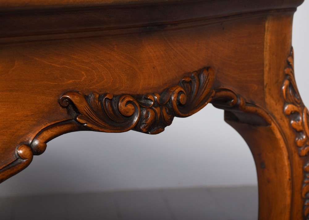 A Georgian style mahogany centre table featuring carved cabriole legs, scroll feet, and a serpentine shaped apron. View VI