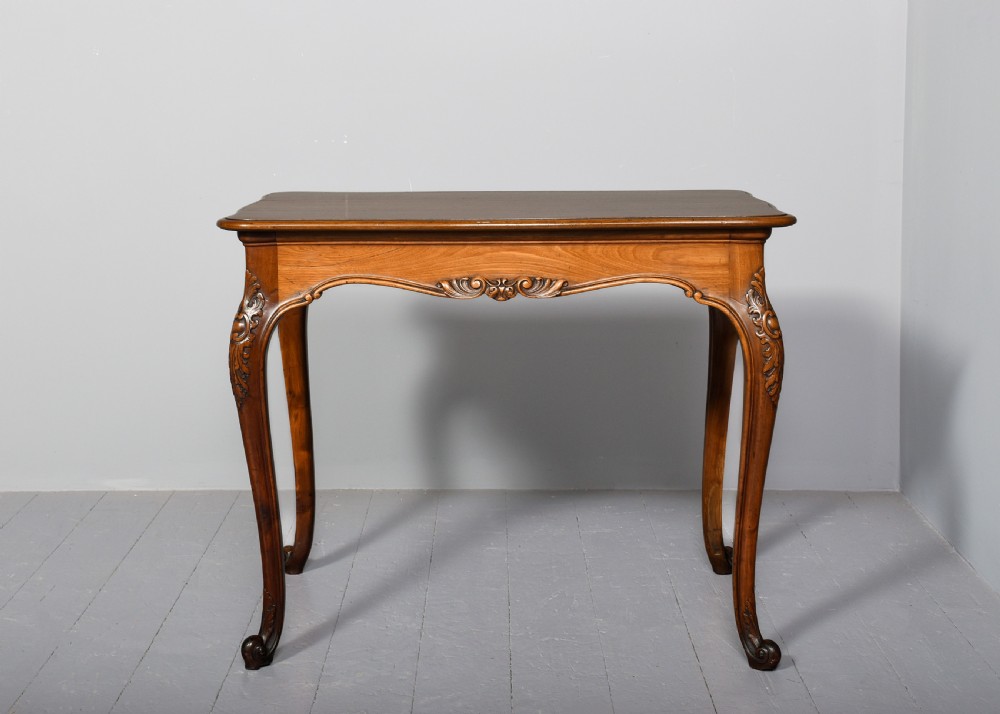 A Georgian style mahogany centre table featuring carved cabriole legs, scroll feet, and a serpentine shaped apron. View VII