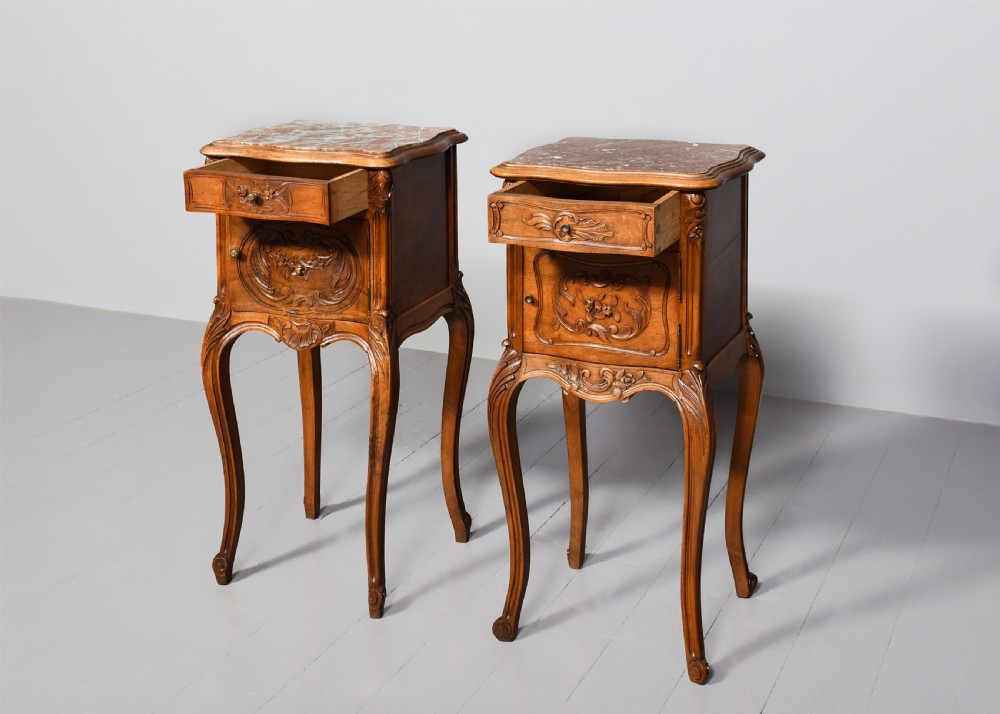 A pair of carved walnut French Louis XIV style bedside cabinets featuring marble tops and slender cabriole legs. View V