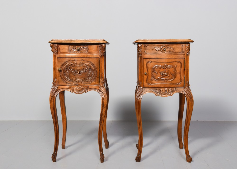 A pair of carved walnut French Louis XIV style bedside cabinets featuring marble tops and slender cabriole legs. View IX