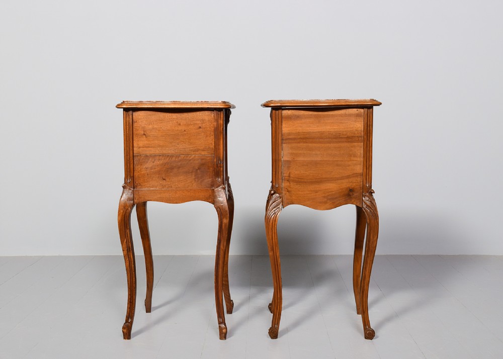 A pair of carved walnut French Louis XIV style bedside cabinets featuring marble tops and slender cabriole legs. View X