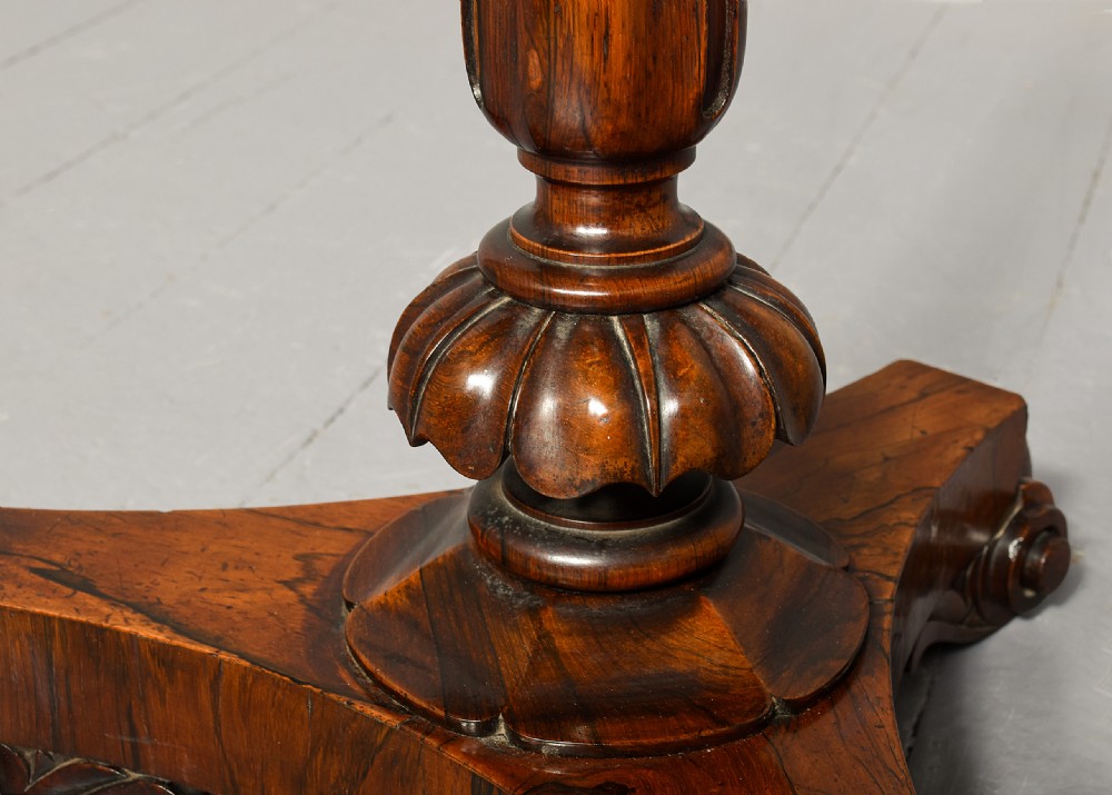 A George IV double-sided rosewood duet music stand featuring carved lyre frames mounted on a brass telescopic stem and a carved triform base. View XI