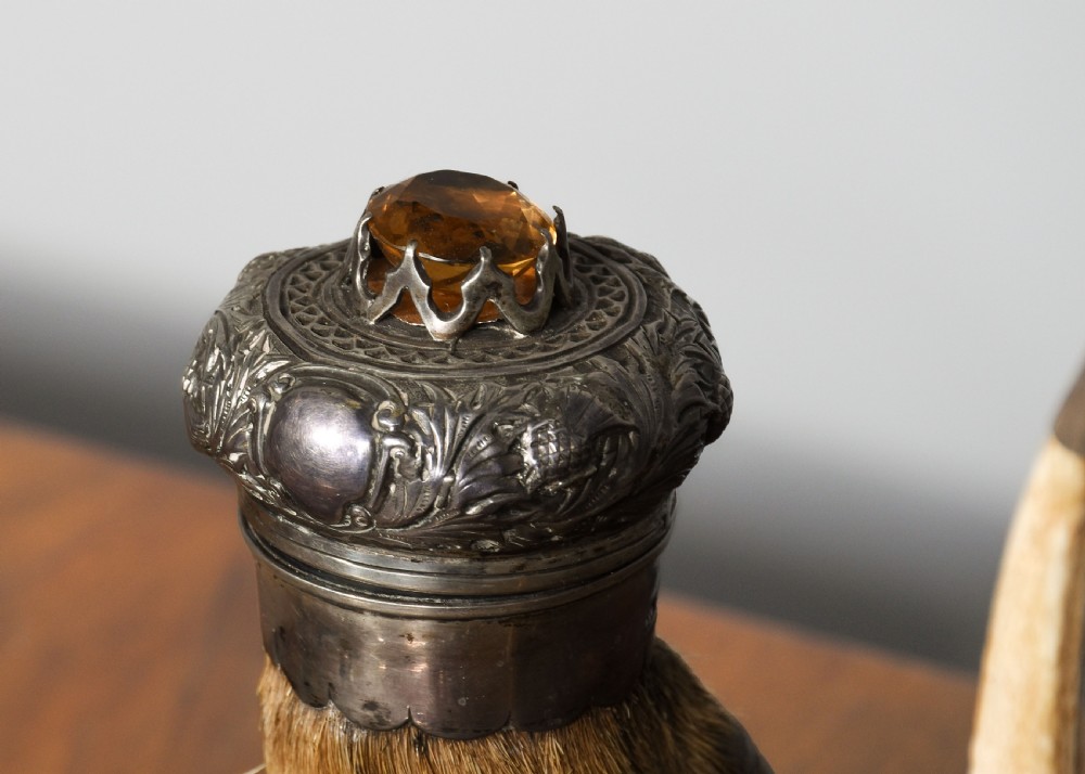 An antique Scottish carved oak desk stand featuring two upright stag antlers as pen rests and a central silver-mounted hoof inkwell. View VI