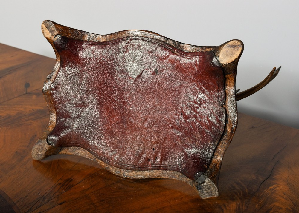 An antique Scottish carved oak desk stand featuring two upright stag antlers as pen rests and a central silver-mounted hoof inkwell. View VII