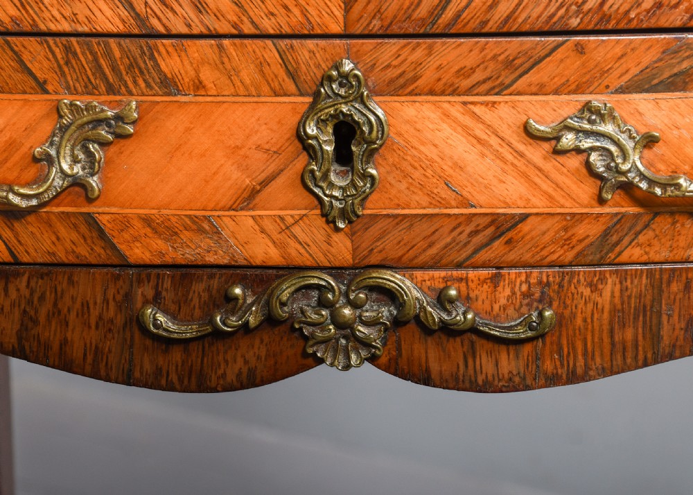 A French Louis XV style side table with a white marble top, three parquetry drawers, brass mounts, and slender cabriole legs. View VIII