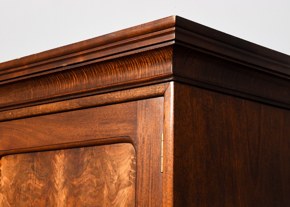 Quality Whytock and Reid neat-sized, two-door mahogany wardrobe with sycamore and figured walnut panelled doors View V