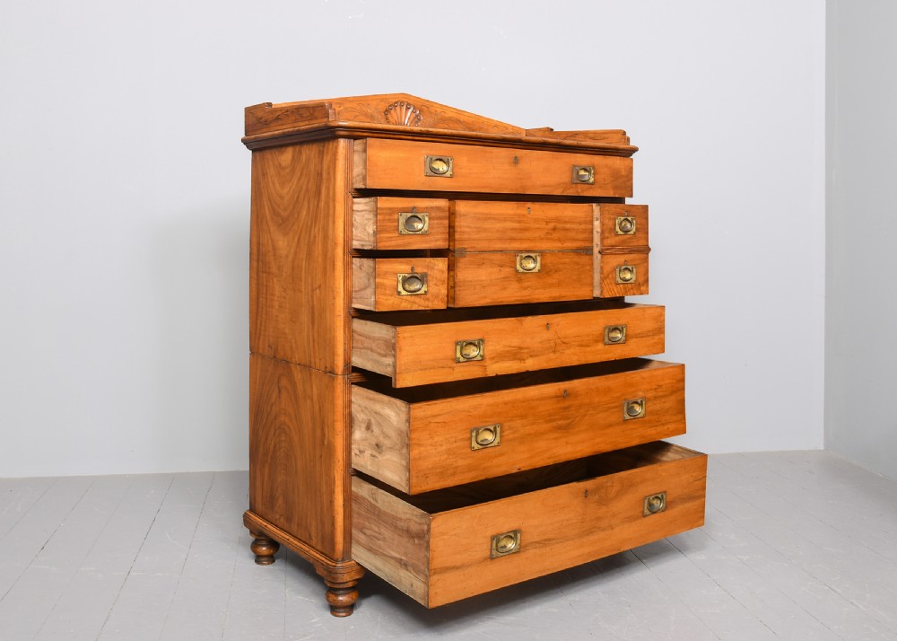 An antique two-part camphorwood military secretaire chest with recessed brass handles and a carved shell cresting. View VI