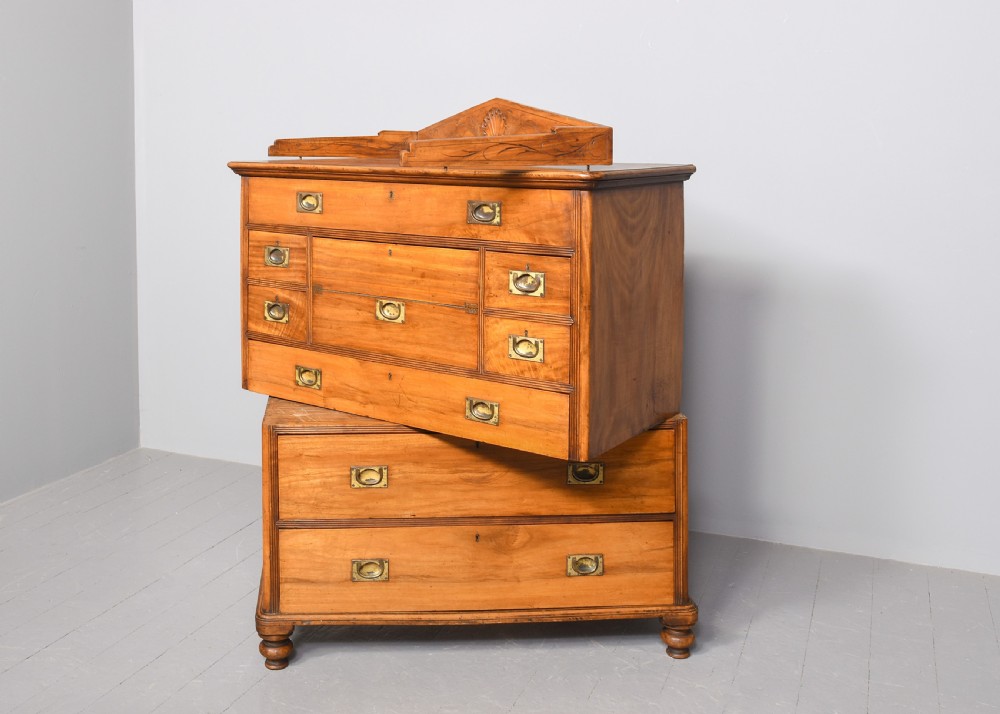An antique two-part camphorwood military secretaire chest with recessed brass handles and a carved shell cresting. View VII