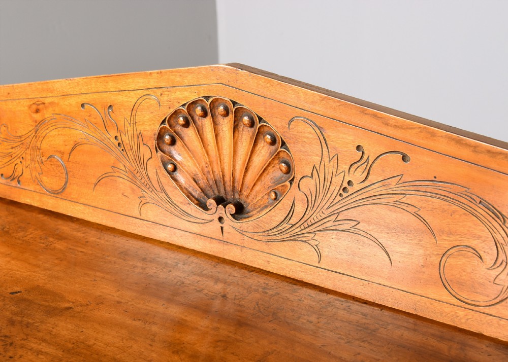 An antique two-part camphorwood military secretaire chest with recessed brass handles and a carved shell cresting. View VIII