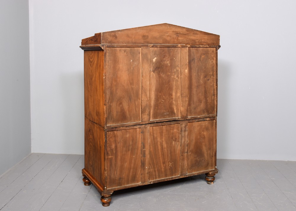 An antique two-part camphorwood military secretaire chest with recessed brass handles and a carved shell cresting. View XII