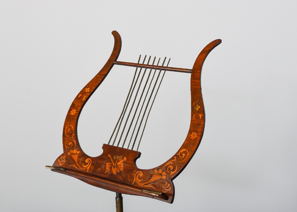 A mahogany music stand featuring a lyre-shaped top rest with floral inlay, an adjustable brass rod, turned column, and a tripod base. View II