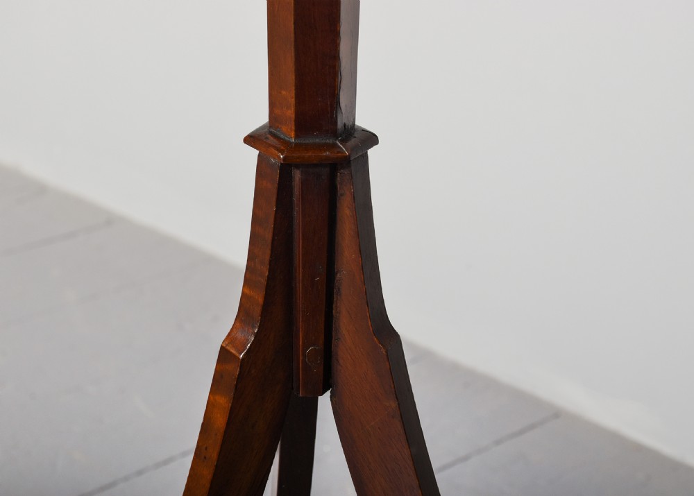 A mahogany music stand featuring a lyre-shaped top rest with floral inlay, an adjustable brass rod, turned column, and a tripod base. View V