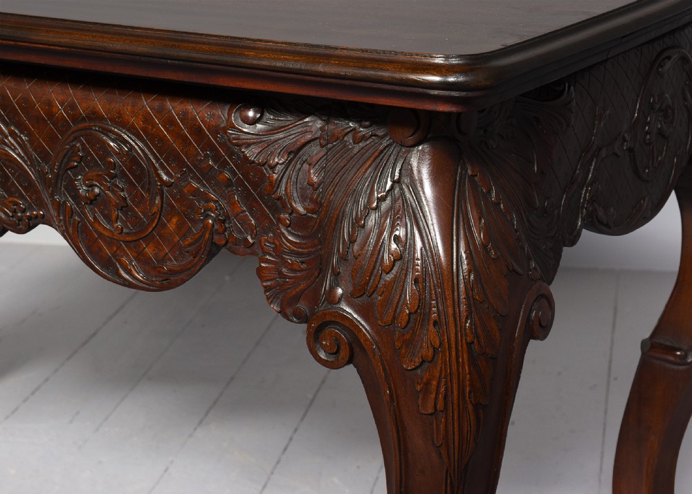 A dark carved mahogany console table in the Irish Chippendale style, featuring a deeply scalloped apron with central shell carving and cabriole legs. View II
