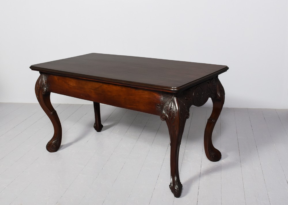 A dark carved mahogany console table in the Irish Chippendale style, featuring a deeply scalloped apron with central shell carving and cabriole legs. View VIII