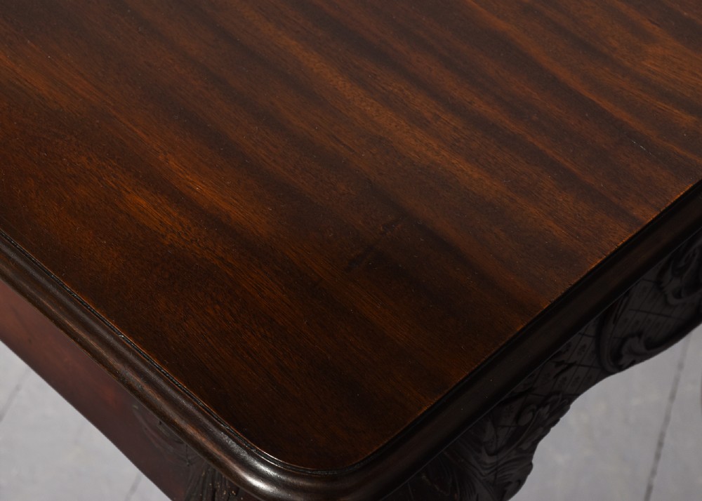 A dark carved mahogany console table in the Irish Chippendale style, featuring a deeply scalloped apron with central shell carving and cabriole legs. View X