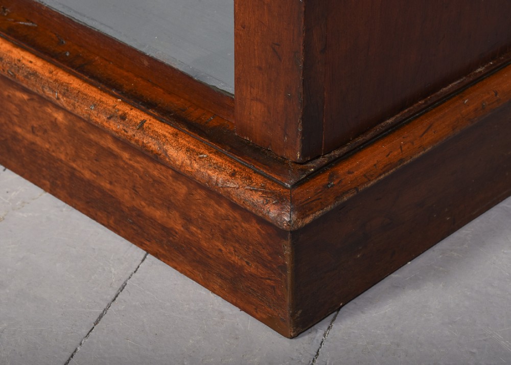 A large Victorian mahogany breakfront open bookcase featuring three sectioned compartments with adjustable shelves and a grey painted interior background. View II