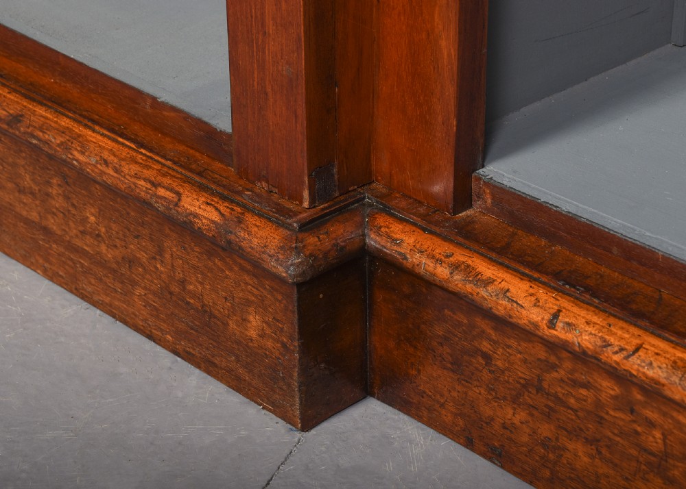 A large Victorian mahogany breakfront open bookcase featuring three sectioned compartments with adjustable shelves and a grey painted interior background. View VII