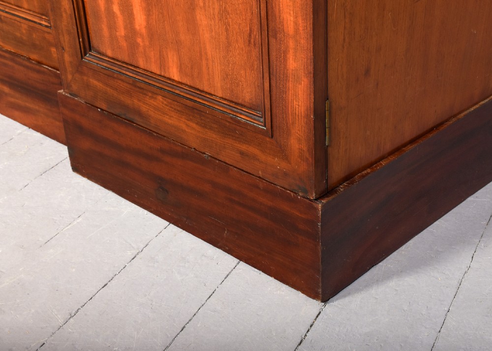 A George IV flame mahogany four-door wardrobe with a breakfront profile and moulded cornice. View XIII