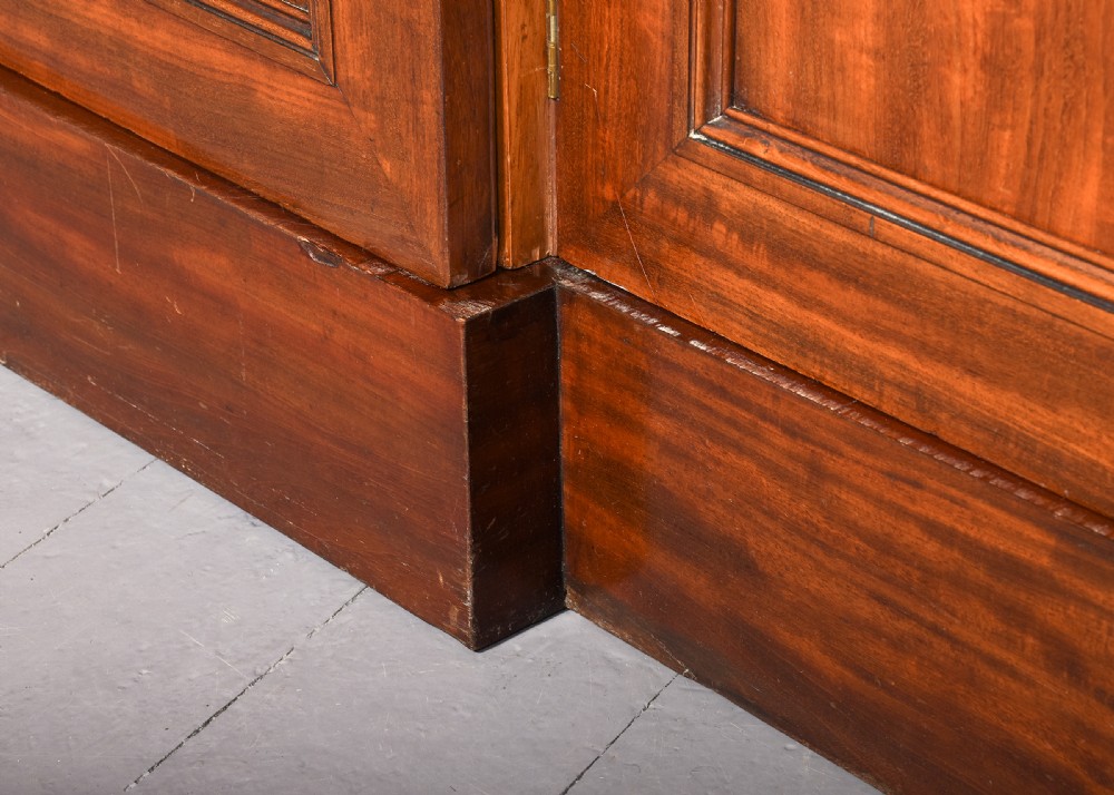 A George IV flame mahogany four-door wardrobe with a breakfront profile and moulded cornice. View XIV