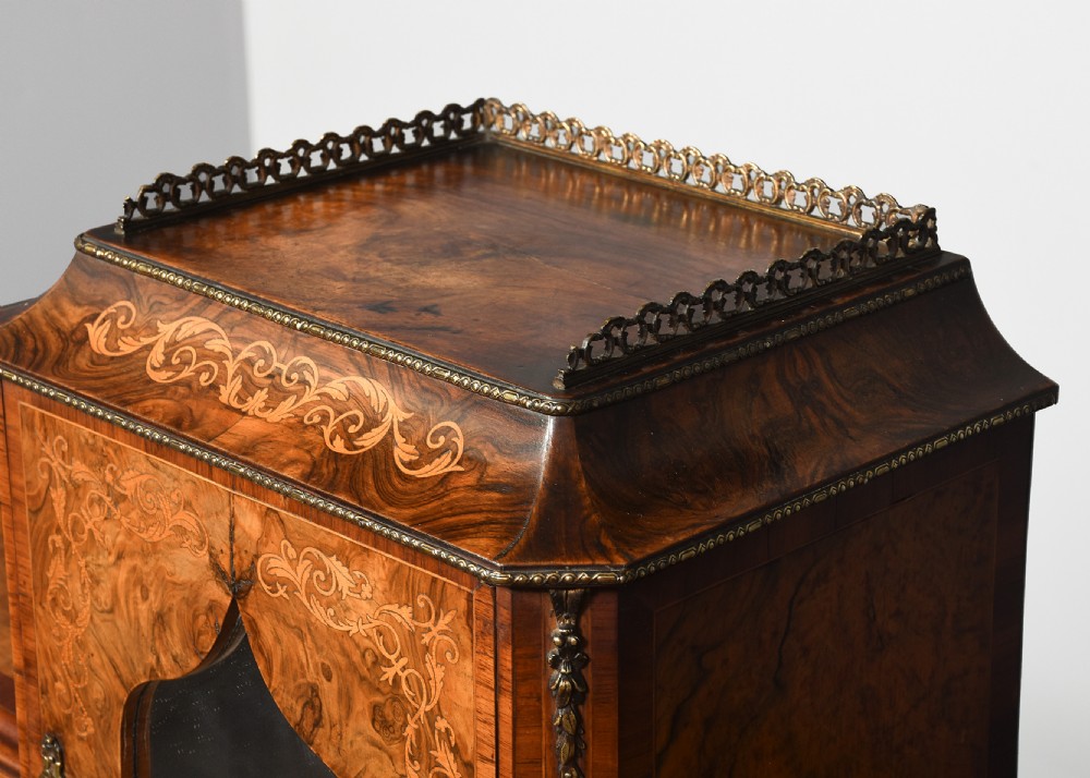 A Victorian figured walnut bonheur de jour writing desk featuring marquetry inlays, a mirrored central cabinet, brass gallery rail, and slender cabriole legs. View VIII